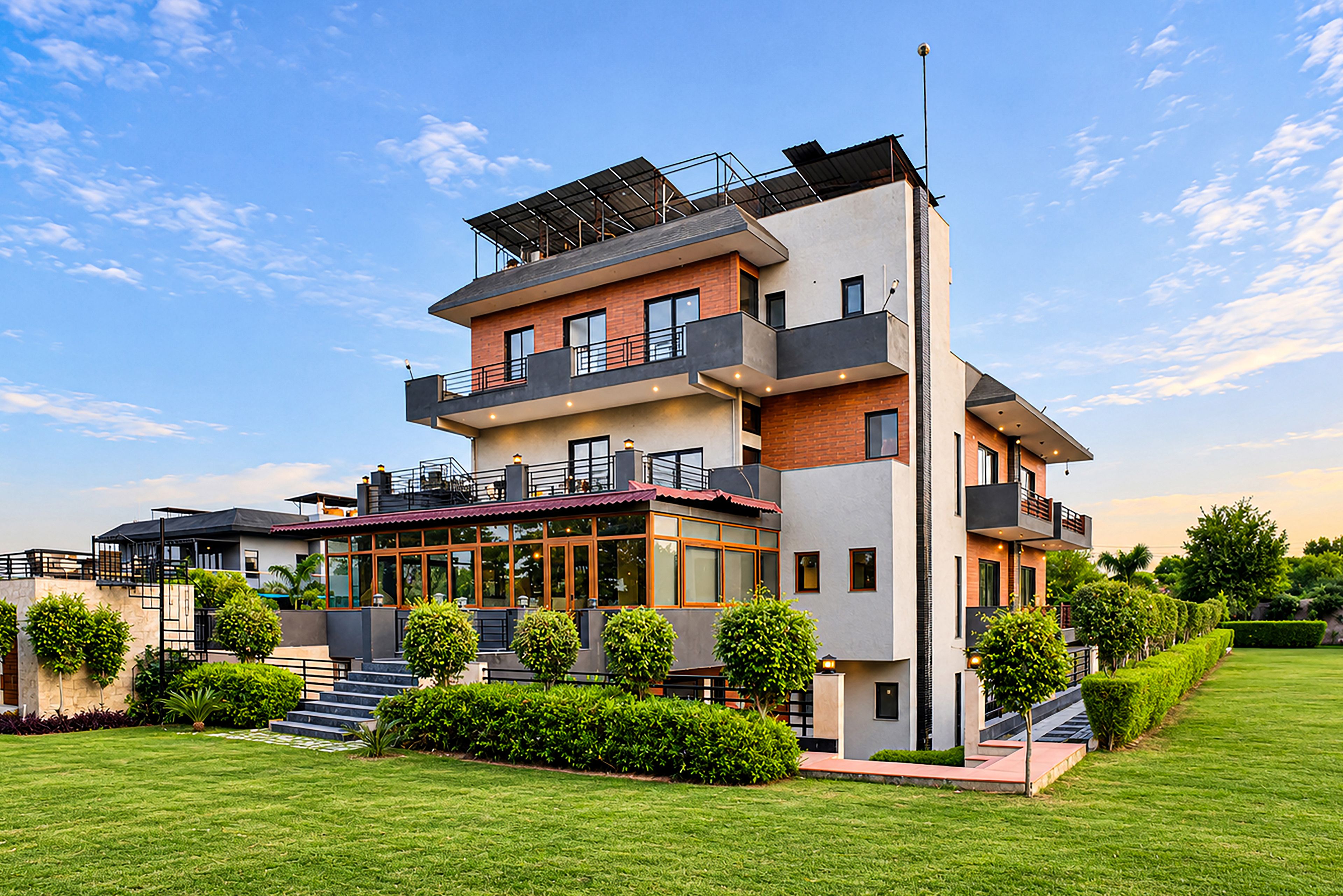 A multi-story residential building with a flat roof, balconies, and a covered outdoor area.