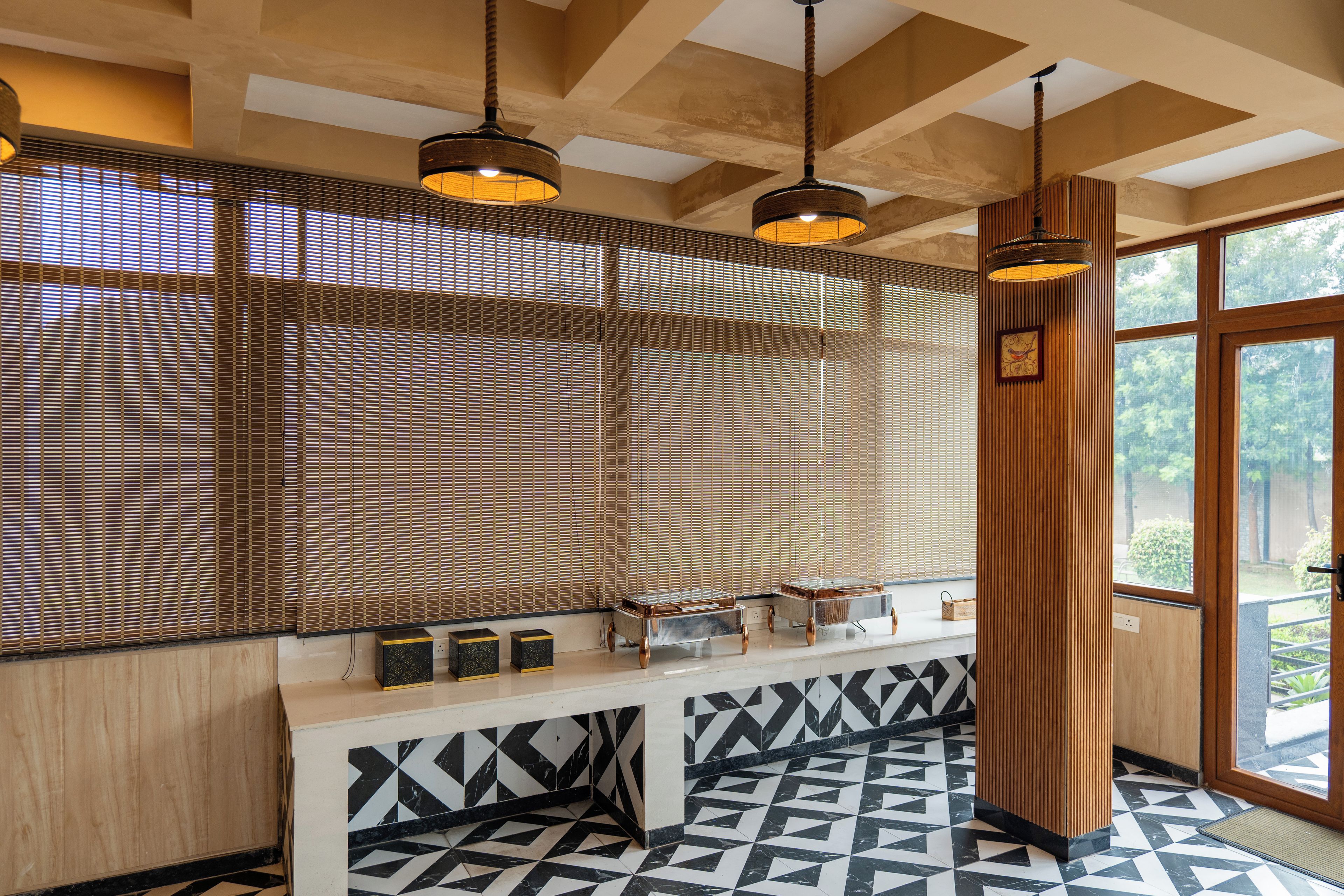 A modern interior with a wooden slatted wall, a reception desk, and a patterned floor.