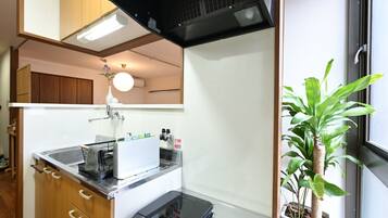 A compact kitchen with a microwave, sink, and cabinets.