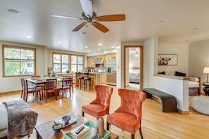 A spacious living area with a dining table, two armchairs, and a sofa. - Sun Valley Extended Stay: Central Condo w/ Patio (Ketchum)