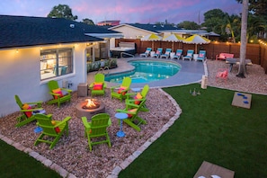 A backyard with a swimming pool, outdoor seating, and a fire pit. - Pool Hot Tub Putt Putt Game Room Karaoke (Largo)