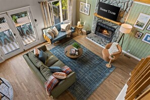 A modern living room with a sofa, coffee table, and fireplace. - Starry Skies Sauna S Mores Pickleball Retreat (Blue Ridge)