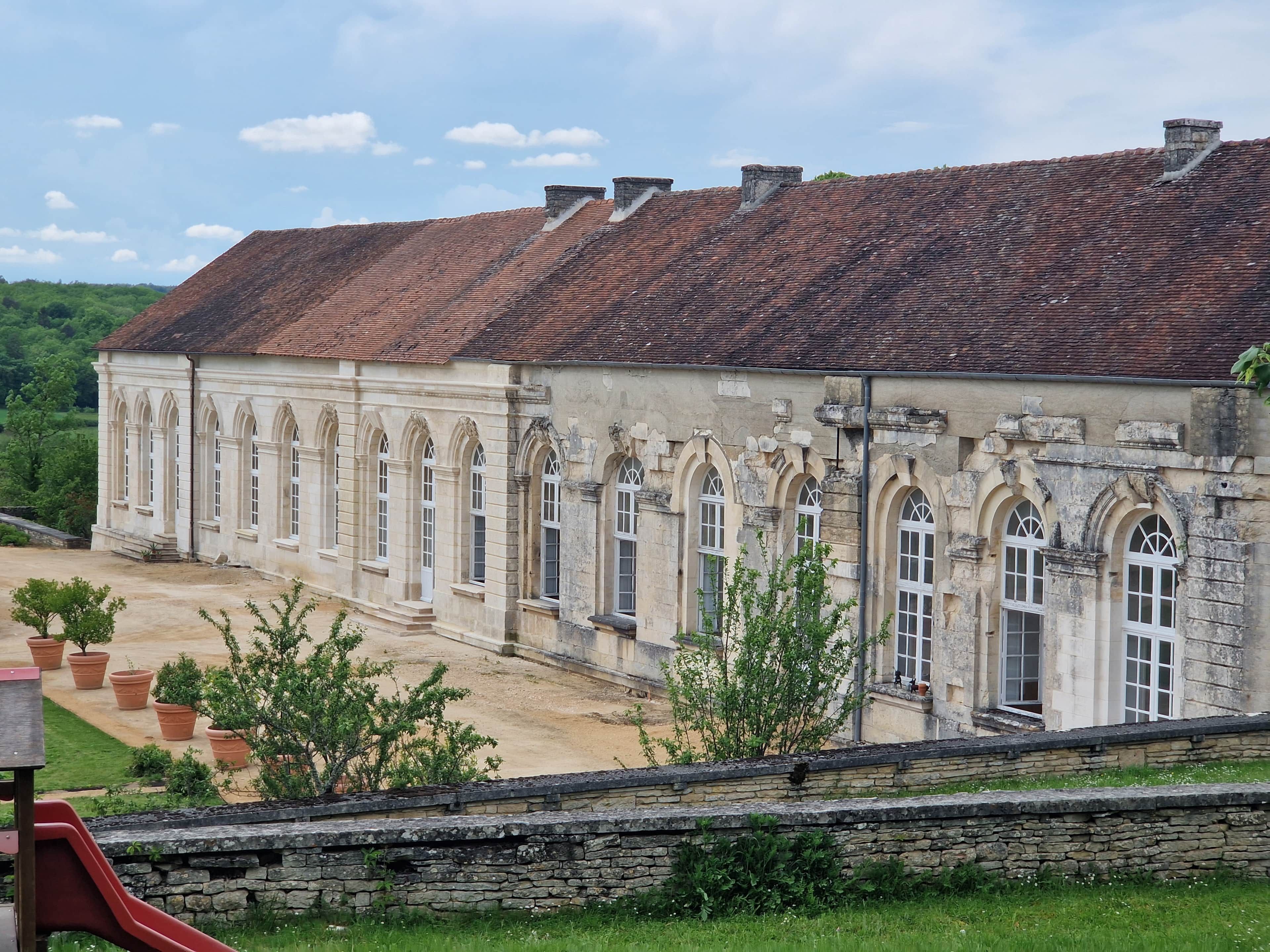 A historic building with a tiled roof and arched windows.
