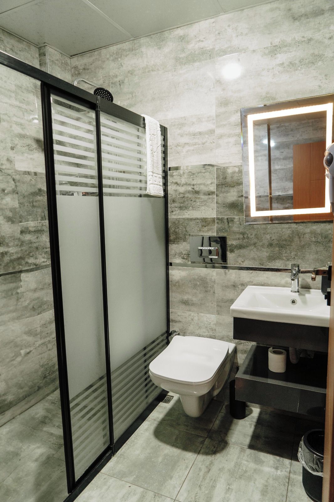 Ein Badezimmer mit Toilette, Waschbecken und Spiegel.