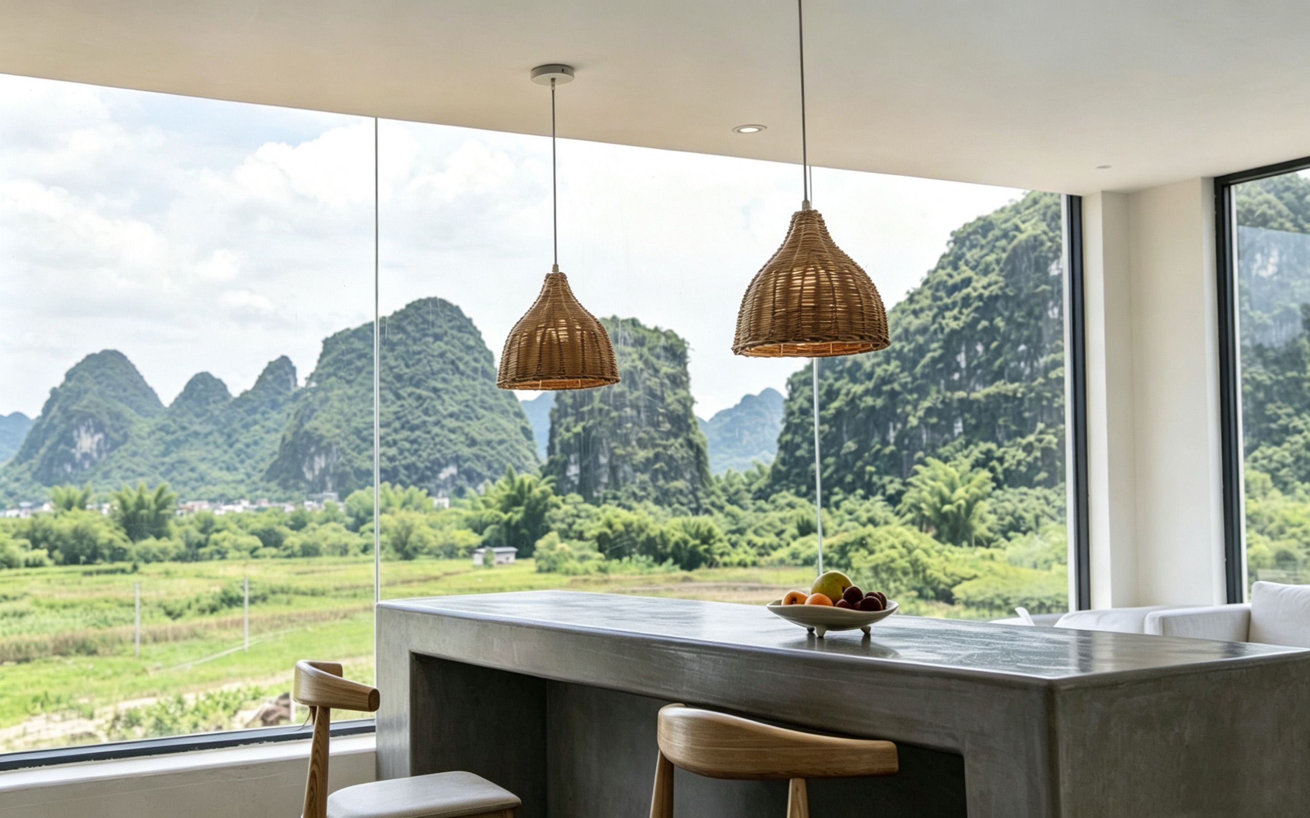 A modern kitchen with a large window overlooking a mountainous landscape.