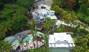 A resort with multiple buildings, a swimming pool, and lush tropical vegetation. - Copy of Duplex Papaye Deshaies. Sea view. Swimming pool (Deshaies)