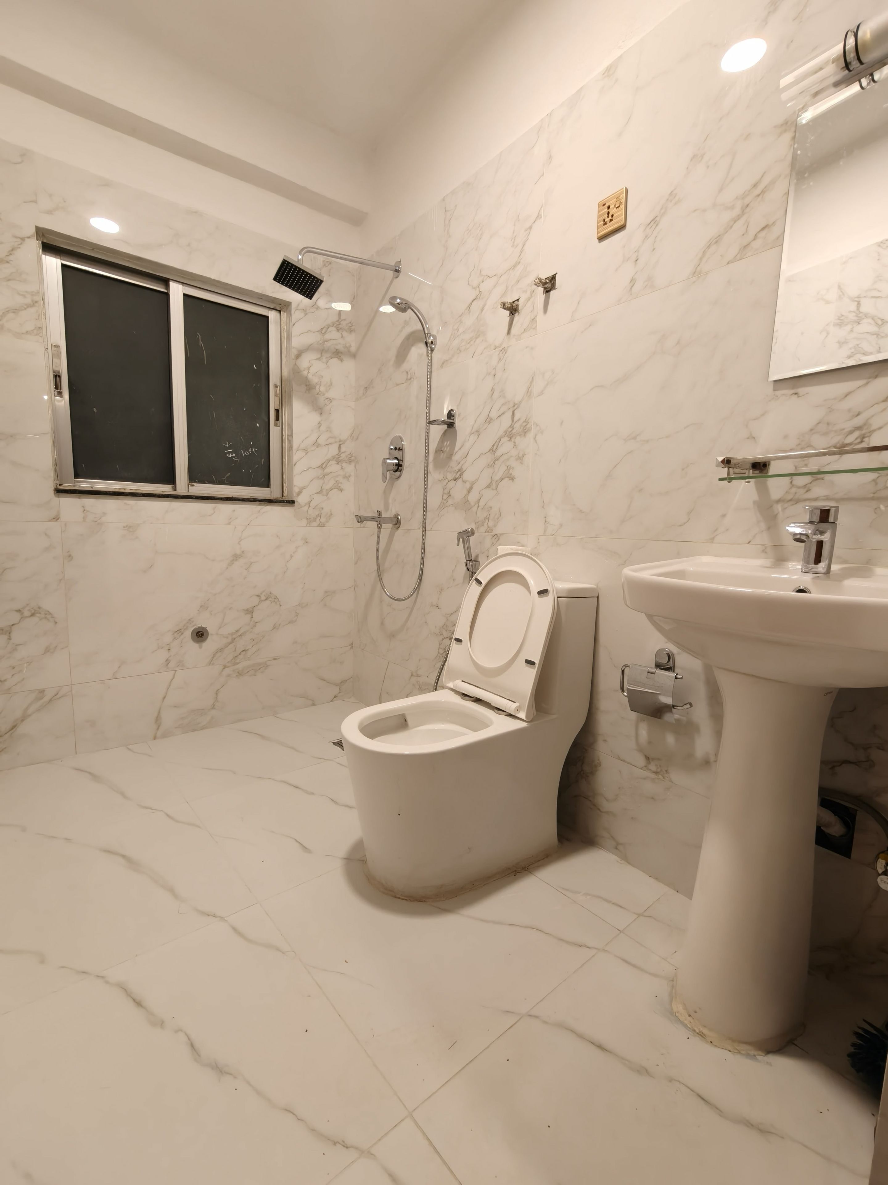Un baño con inodoro, lavamanos y ducha.