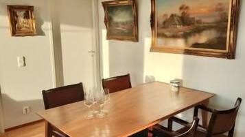 Sunny dining nook with seating for four and stylish artwork