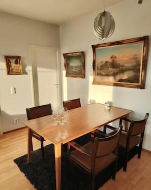 Sunny dining nook with seating for four and stylish artwork