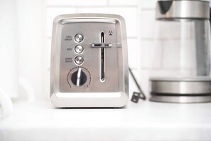 A stainless steel toaster with multiple settings on a white countertop. - Cute Studio in DT Montreal, 5 mins to bell center (Montreal)
