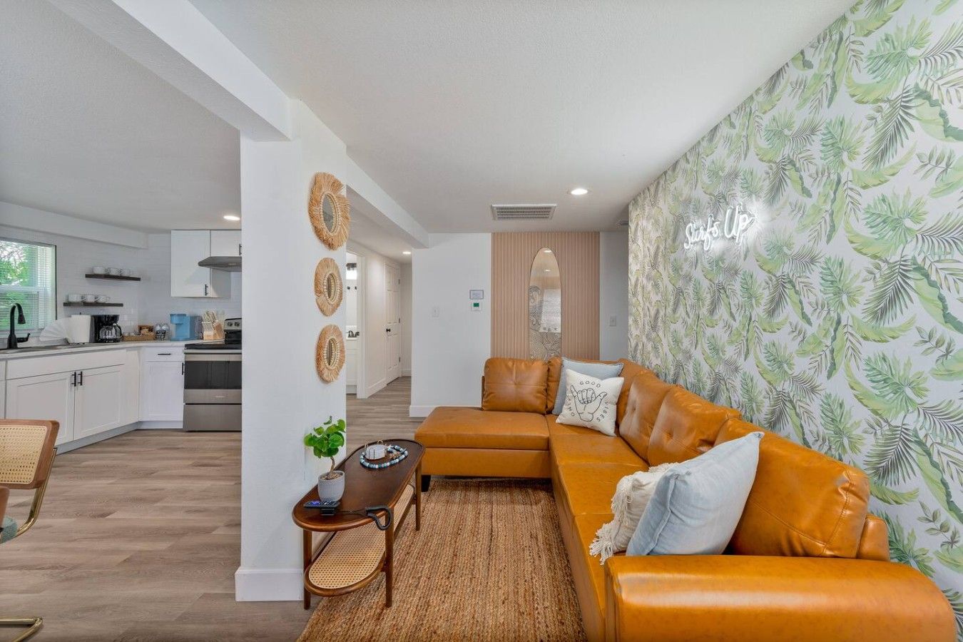 A modern living room with a sofa, a coffee table, and a decorative wall.