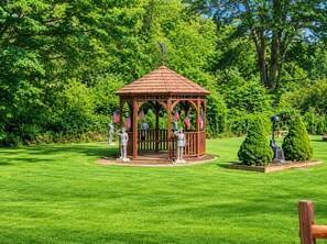 A gazebo with statues of soldiers, surrounded by well-maintained grass and trees. - Pocono Chalet Fireplace, Loft & Resort Fun (Lake Ariel)
