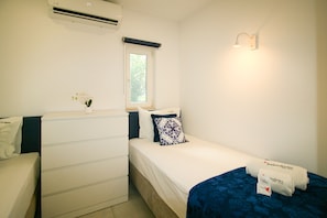 A hotel room with a bed, a bedside table, a dresser, a window, and a wall-mounted light fixture. - FLH Vale do Lobo Delightful Terrace (Vale do Lobo)