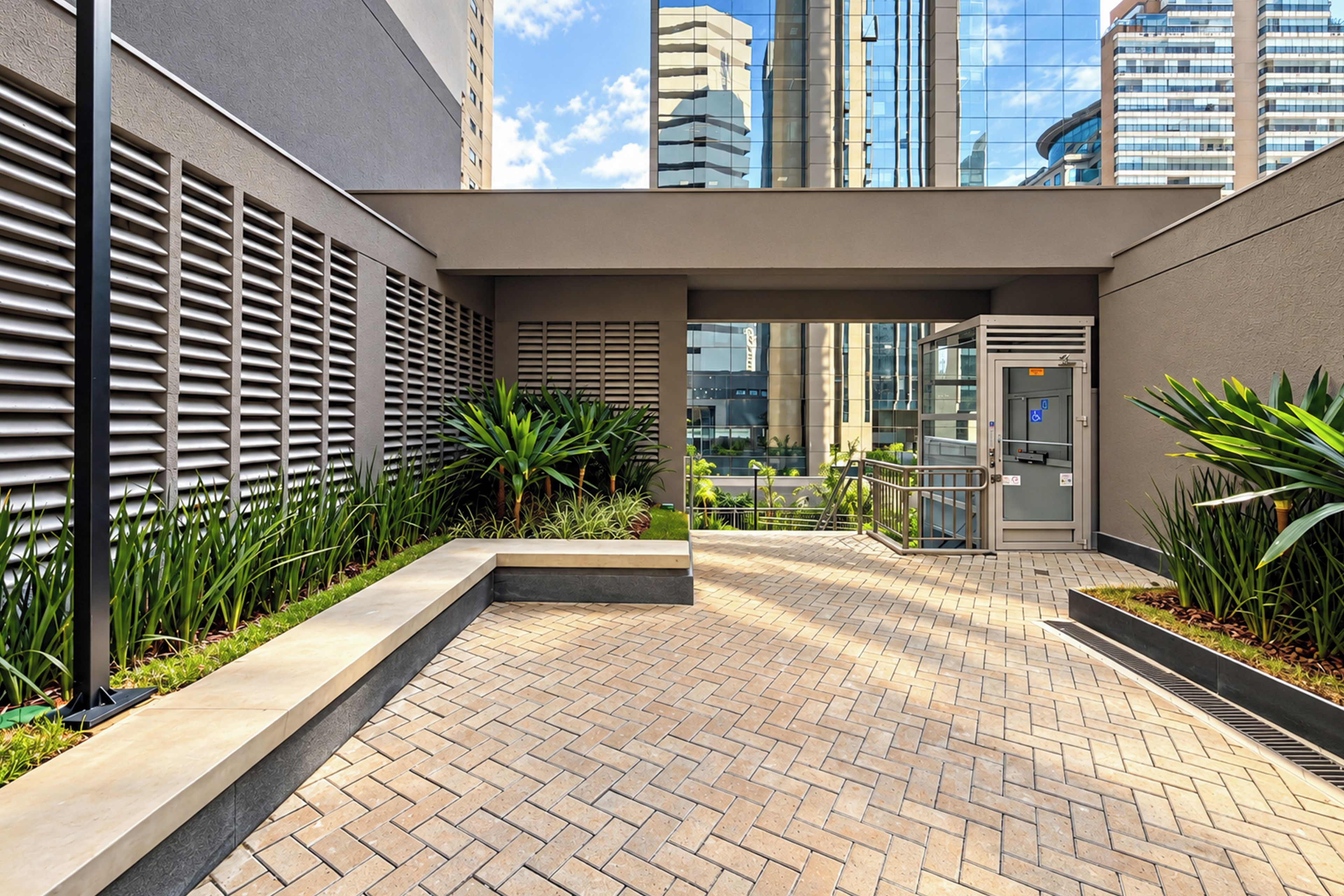 A modern outdoor area with a brick pathway, metal railings, and greenery.
