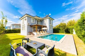 A two-story house with a swimming pool, outdoor seating area, and a covered patio. - Villa Dogakent 4 - Four Bedroom Villa, Sleeps 8 (Okçular)