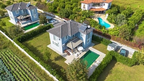 A large two-story house with a swimming pool, a covered patio, and a garden. - Villa Dogakent 1 - Four Bedroom Villa, Sleeps 8 (Okçular)