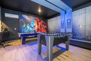 A room with a foosball table, a large Star Wars movie poster, and a wall with a grid of electrical boxes. - The best 9-suite house at Sonoma Resort (Kissimmee)