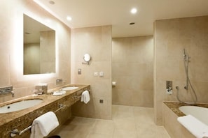 A modern bathroom with a double sink vanity, a large mirror, a walk-in shower, and a bathtub. - Valley Lodge Conference and Spa (Magaliesburg)