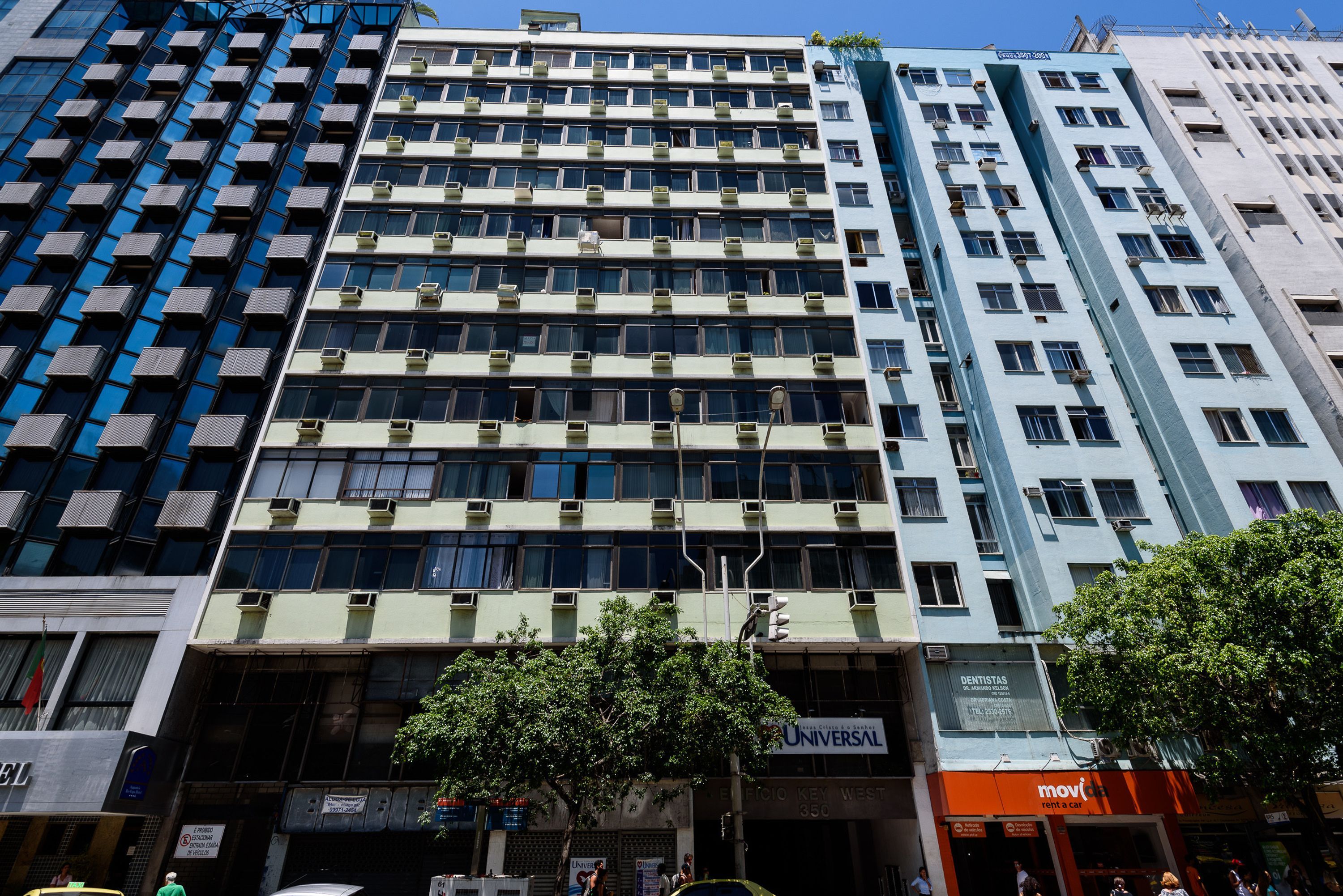 A multi-story building with a mix of commercial and residential spaces, including a visible storefront with signage.