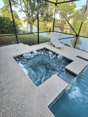A hot tub with a view of a body of water and trees. - Amazing Canal Home, Heated Pool, Spa & Fishing (Cape Coral)