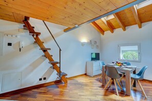 A modern interior with a wooden staircase, a dining area, and a window with a view. - Historic Palazzo Gritti - Lugano Lakefront Stay - Vaniglia, Morcote, Switzerland (Morcote)