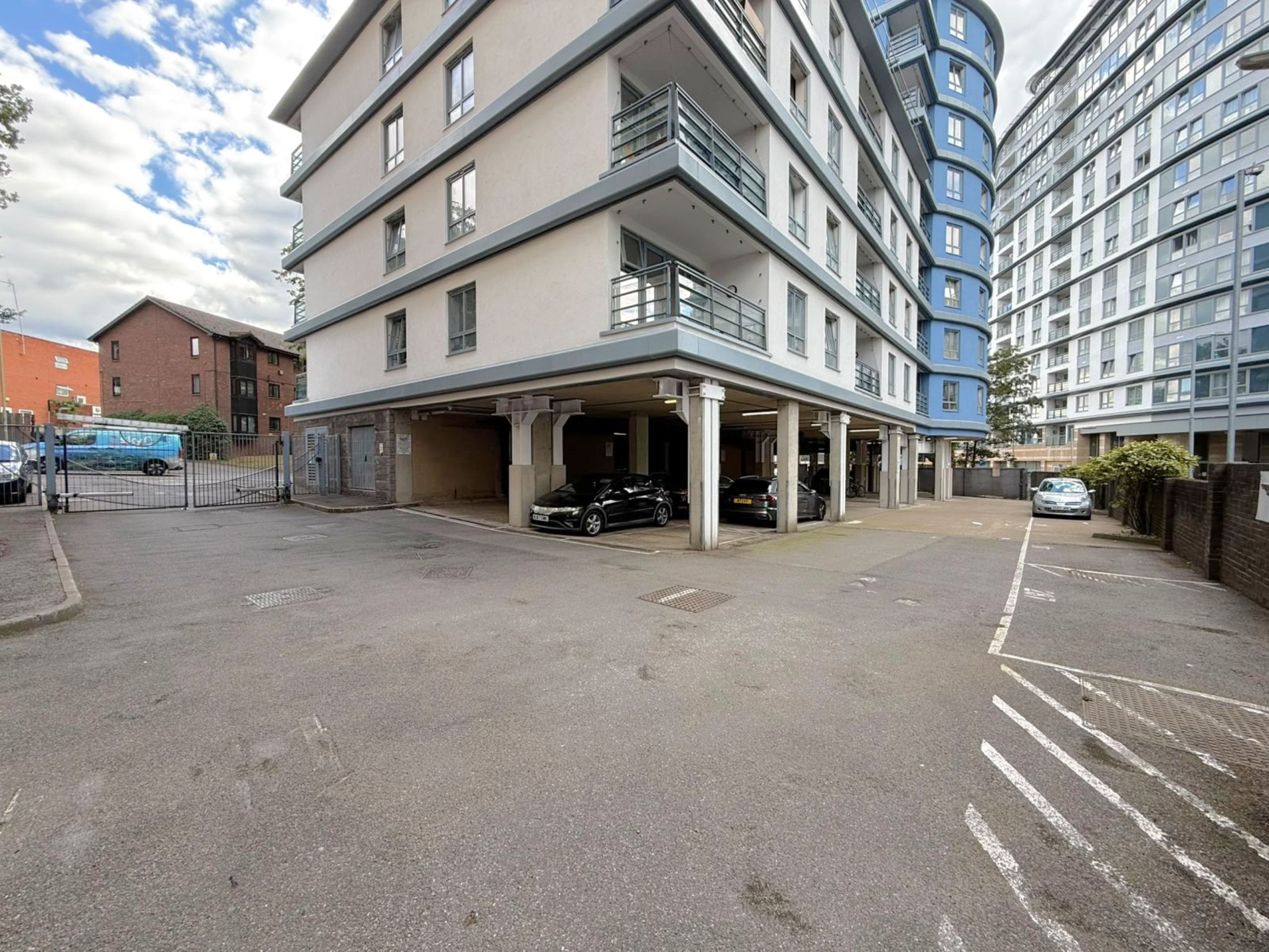A multi-story parking garage with several cars parked inside.