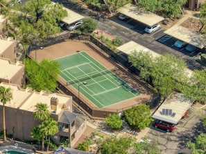 An aerial view of a residential area with a tennis court surrounded by trees and a parking lot. - Catalina Cozy, Foothills Retreat with Screened Patio (Tucson)