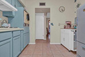 A kitchen with a microwave, kettle, and coffee maker. - Atomic Agave, Mid-Century Tucson Retreat (Tucson)