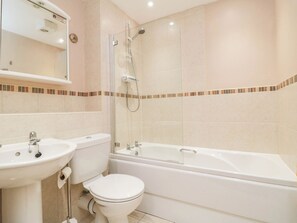 A bathroom with a toilet, sink, and bathtub. - Apartment 17, St. John's (Whitby)