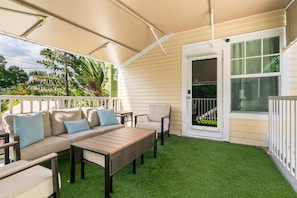 An outdoor patio with a sofa, chairs, and a table. - Cozy 1-bedroom Apartment Suite+ Pool & Hot Tub (Key West)