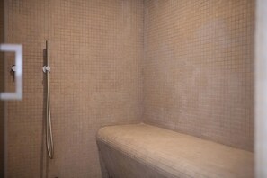 A bathroom with tiled walls and a shower area. - Luxury Trulli Zaccano Estate with Private Pool, Cisternino (Puglia)
