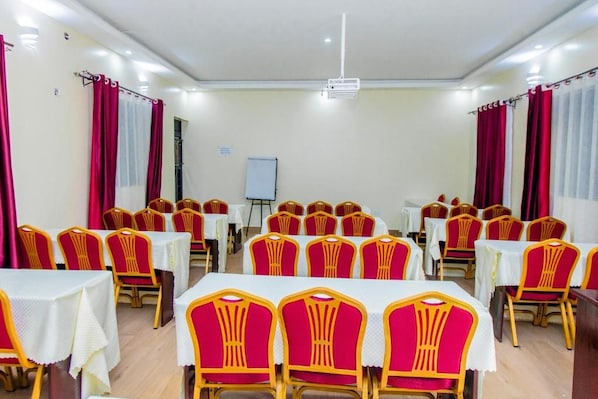 A conference room with tables and chairs arranged for meetings. - Belmont Hotel Mbale (Mbale)