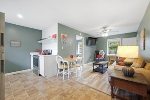 A compact living space with a kitchenette, dining area, and seating area. - Retreat at Delano | Near Hiwassee & Scenic Railway (Delano)