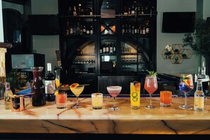 A bar with a variety of drinks and bottles.