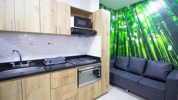 A modern kitchen with wooden cabinets, a built-in microwave, a gas stove, and a built-in oven.