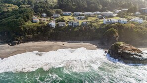 A coastal residential area with houses on a hillside overlooking a beach. - Sundown Cliffs- Premium Coastal Getaway with Breathtaking Ocean Views & Sunsets (Cloverdale)