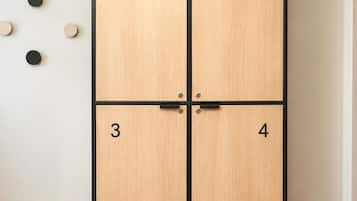 Un armario de cuatro puertas con puertas numeradas, marco negro y acabado de madera.