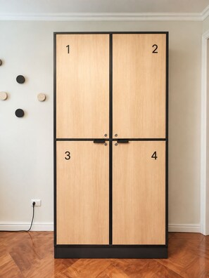 A four-door wardrobe with numbered doors, a black frame, and a wooden finish.