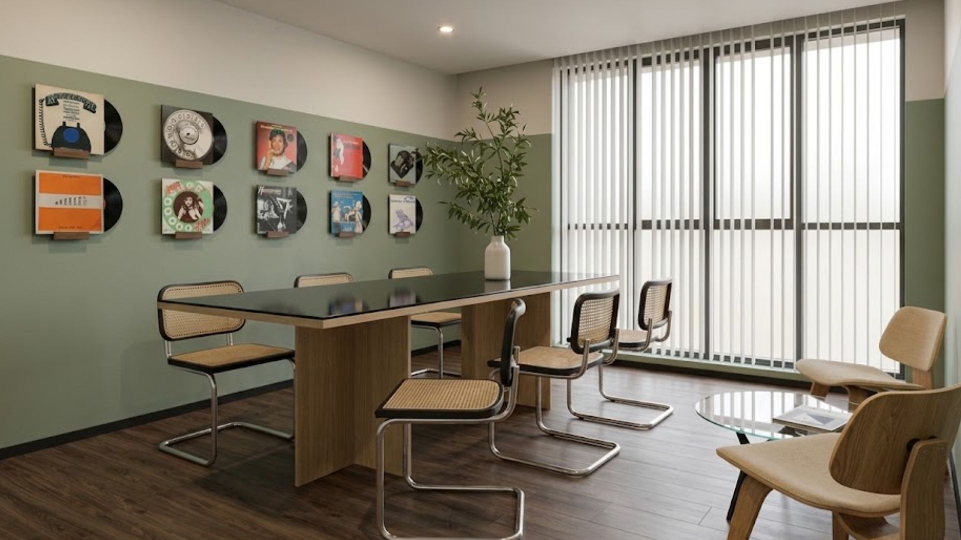 A conference room with a long table, six chairs, and a potted plant.