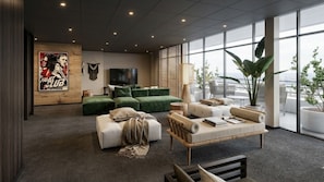 A modern living room with a sectional sofa, a coffee table, and a television. There is a large window providing a view of the outdoors. - Appart'Hôtel Bikube - Paris Suresnes (Suresnes)