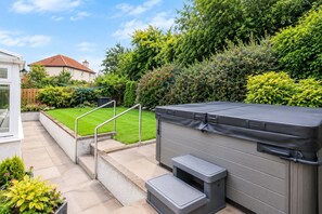 A patio with a grill, steps, and a view of a house and garden. - Hot Tub,Parking,Nr Edinburgh,Contractor Stay,4BED (East Lothian)