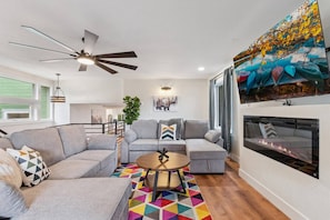 Bright and welcoming living area with plenty of seating—the perfect spot to relax, stream your favorite shows, or enjoy quality time.