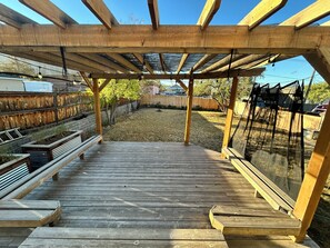 A wooden deck with built-in benches and a pergola structure. - Millcreek MTN Home. - 2 bdm 1 bth, full kitchen, (Salt Lake City)