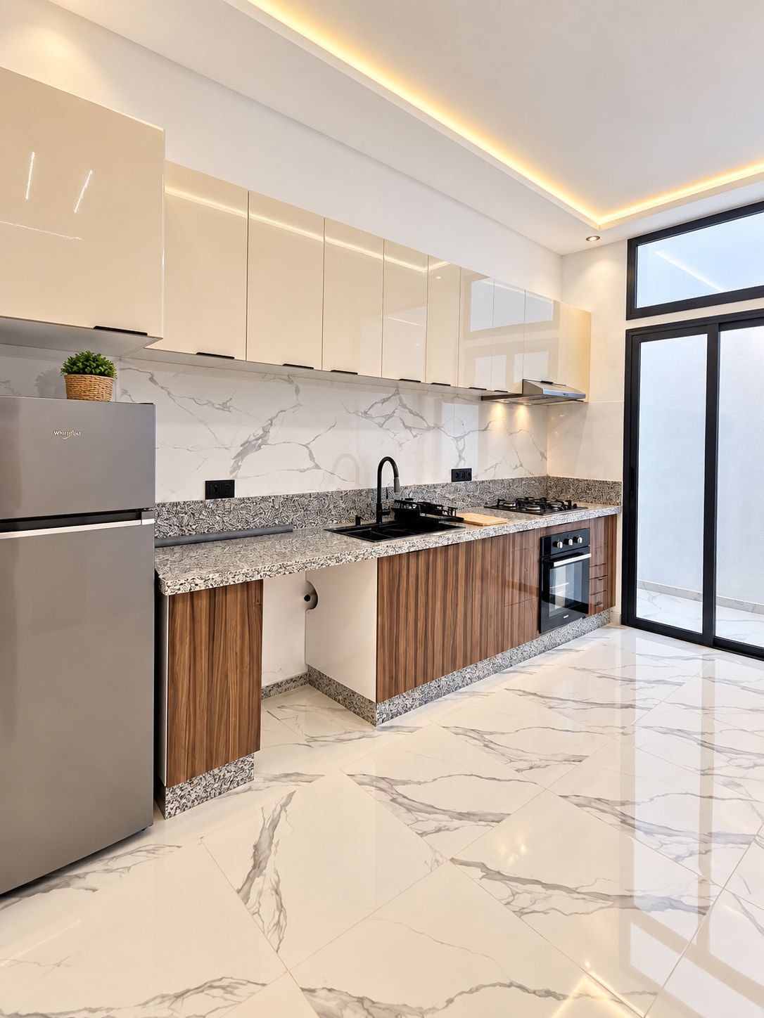 A modern kitchen with a marble countertop, stainless steel appliances, and wooden cabinetry.