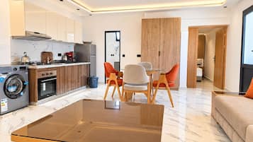 A modern apartment with a kitchen, dining area, and living room.