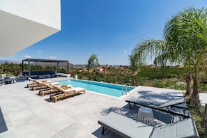 A rooftop pool area with lounge chairs and a view of the surrounding landscape. - Three Bedroom Villa in Nafplio (Nafplio)