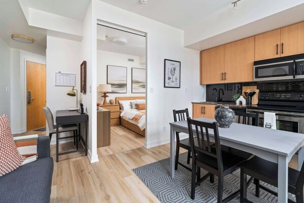 A modern apartment with a dining area, kitchen, and living space. - City View 1BR - Walk to CN Tower & Union Station (Toronto)