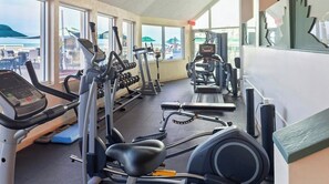 A gym with various exercise equipment, large windows, and a view of the beach. - THANKSGIVING BEACH VACATION!!! ROYAL FLORIDIAN RESORT ORMOND BCH FL 7-DAY RENTAL (Ormond Beach)
