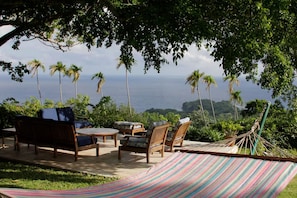 A hammock, wooden furniture, and a view of the ocean. - Norse Hill Estate & Botanic Gardens (Port Antonio)
