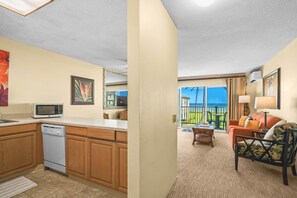 A compact living space with a kitchenette, a dining area, and a balcony with a view. - PK F206 - Ocean View • AC • Pool & Jacuzzi (Kapaa)